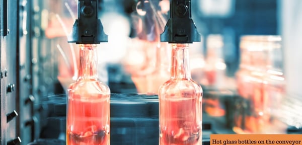 Hot glass bottles on the conveyor