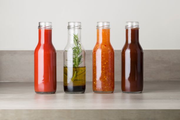 A range of glass sauce bottles, available from Aegg Creative Packaging
